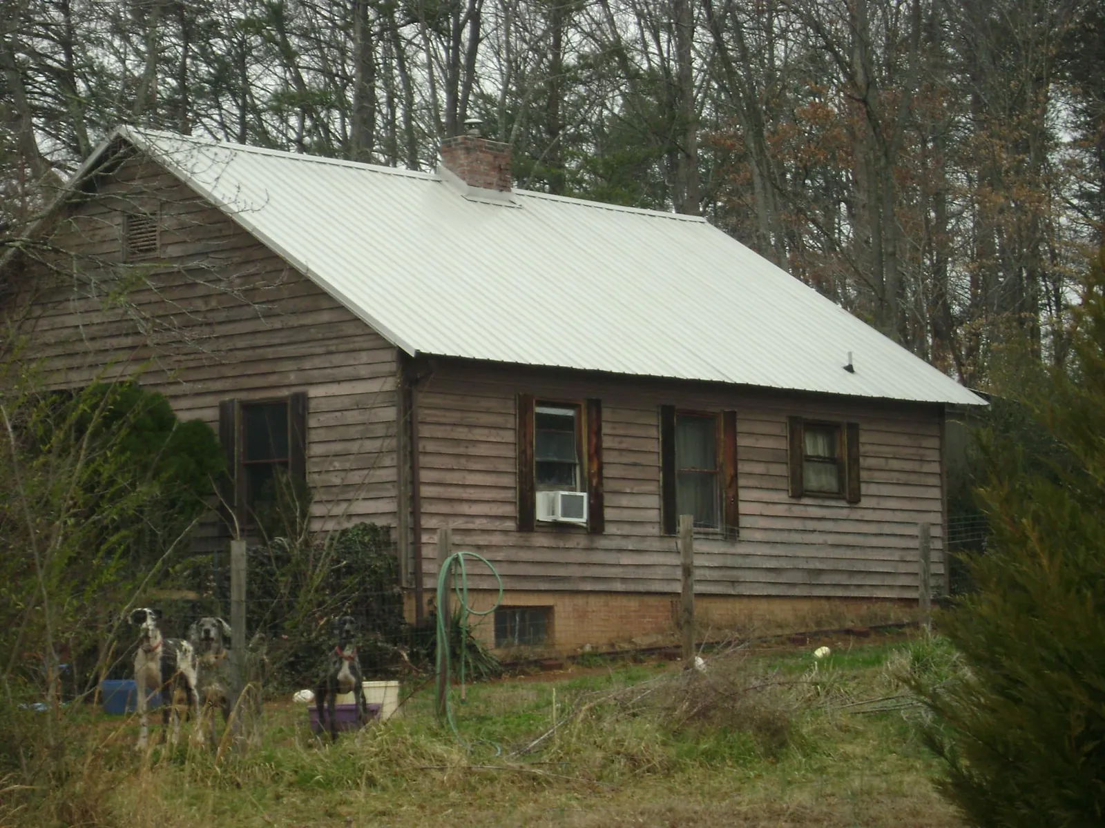 White metal roof on an old wood sided farmhouse, from a Metal Roof Installation job in Langsville